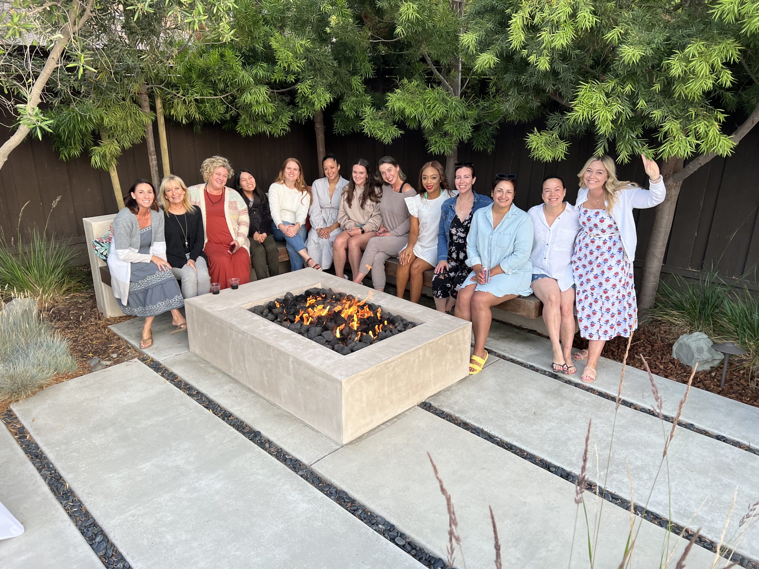 Diverse Members of the Junior League of San Jose gathered around a firepit at an event